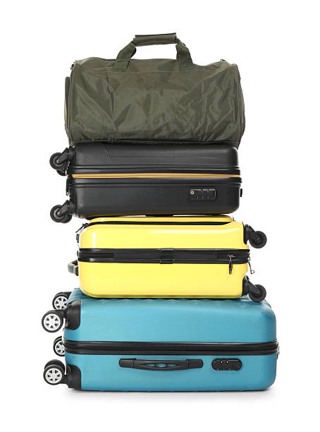 Stack of colorful suitcases and bag isolated on white
