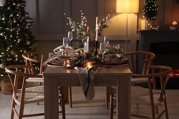 istock Christmas table setting with stylish dishware, glasses and burning candles in festive decorated room 2213231884