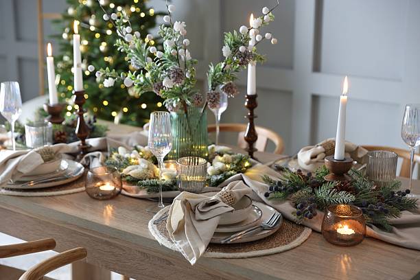 istock Christmas celebration. Festive table setting with dishware, glasses and decor in room 2213231885