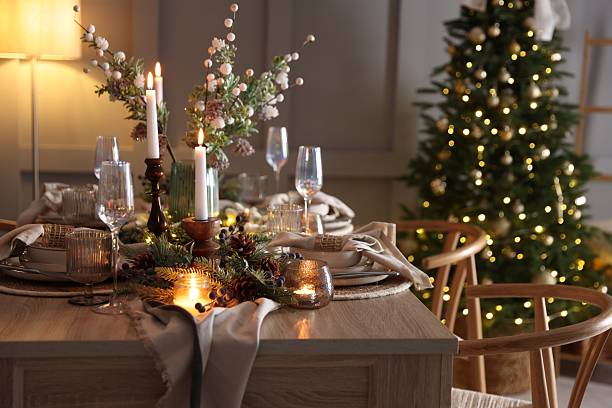 istock Christmas table setting with stylish dishware, glasses and burning candles in festive decorated room 2213231932