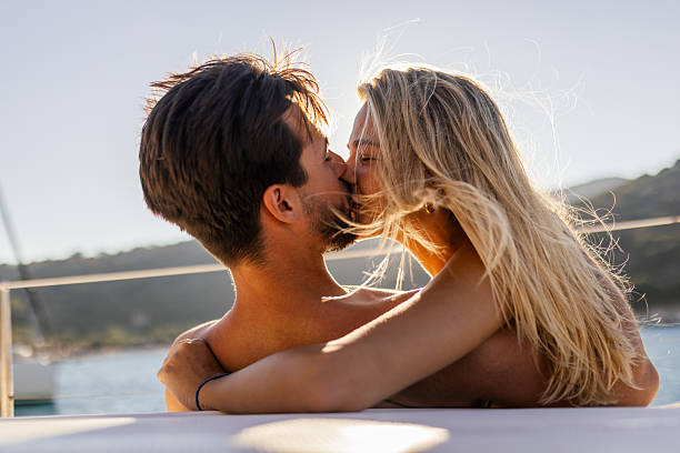 istock Young couple relaxing on sailing in cockpit 2213231946