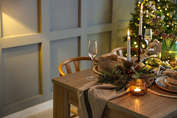 istock Christmas celebration. Festive table setting with dishware, glasses and decor in room 2213231968