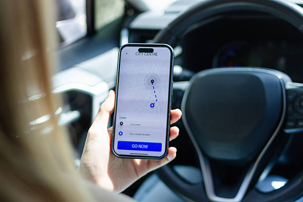istock Woman using gps navigation app on smartphone in car 2213231969