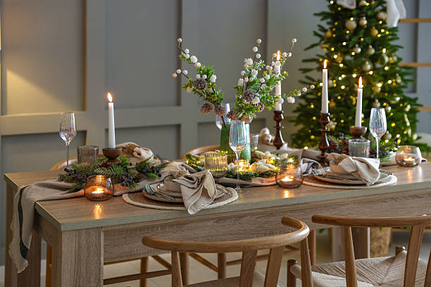 istock Christmas table setting with stylish dishware, glasses and burning candles in festive decorated room 2213231981