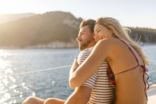 istock Young couple relaxing on sailing in cockpit 2213231988