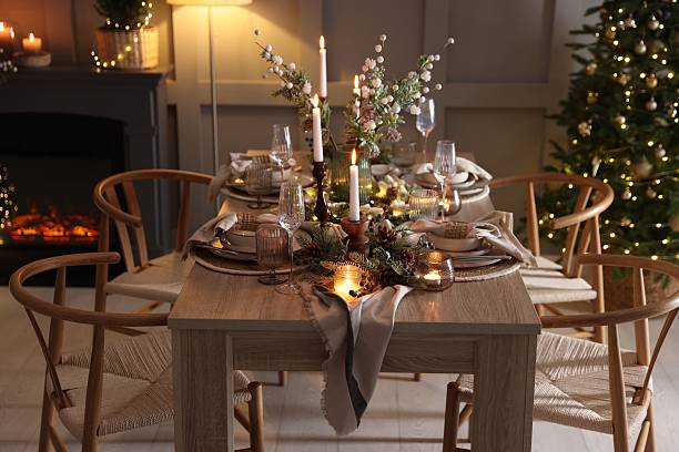 istock Christmas table setting with stylish dishware, glasses and burning candles in festive decorated room 2213232007
