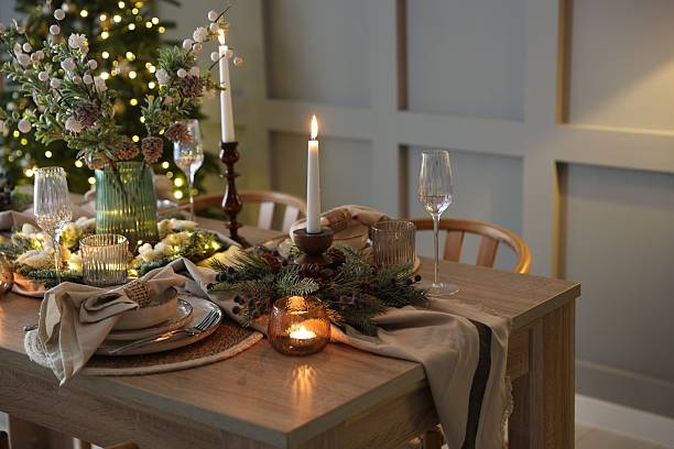 istock Christmas celebration. Festive table setting with dishware, glasses and decor in room 2213232011