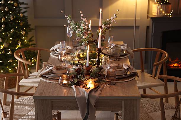 istock Christmas table setting with stylish dishware, glasses and burning candles in festive decorated room 2213232024