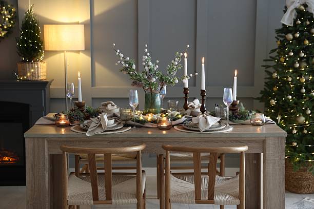 istock Christmas table setting with stylish dishware, glasses and burning candles in festive decorated room 2213232025