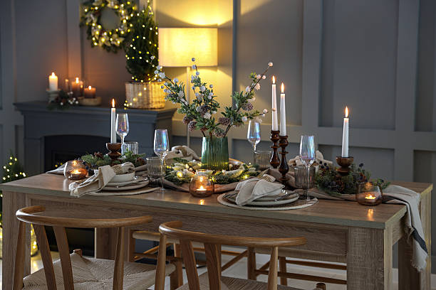 istock Christmas table setting with stylish dishware, glasses and burning candles in festive decorated room 2213232031