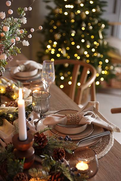 istock Christmas celebration. Festive table setting with dishware, glasses and decor in room 2213232040