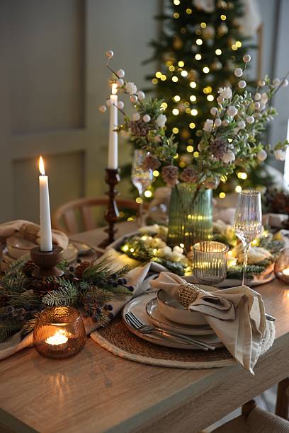 istock Christmas celebration. Festive table setting with dishware, glasses and decor in room 2213232052