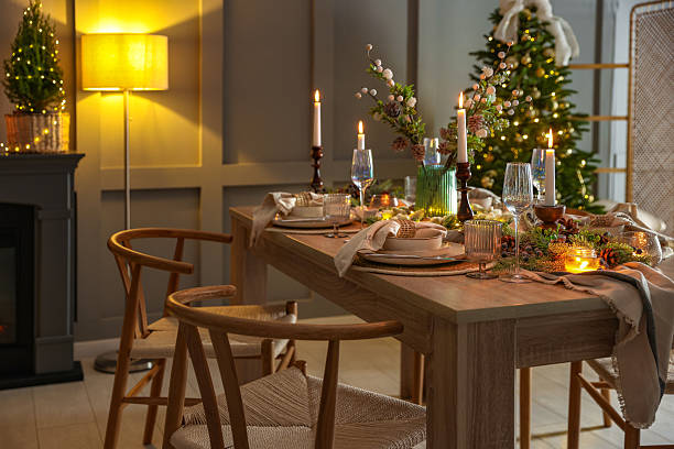 istock Christmas table setting with stylish dishware, glasses and burning candles in festive decorated room 2213232058