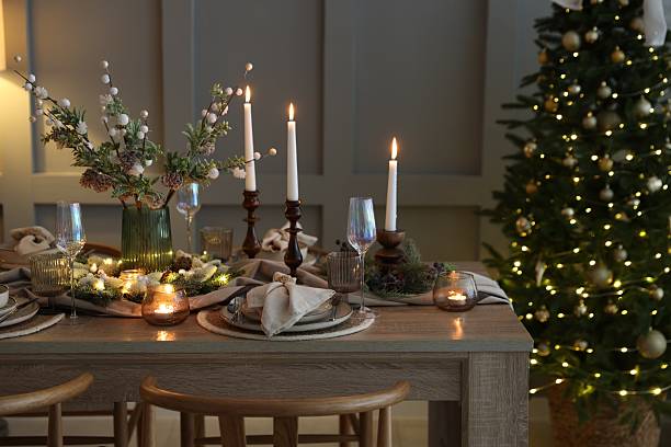istock Christmas table setting with stylish dishware, glasses and burning candles in festive decorated room 2213232060