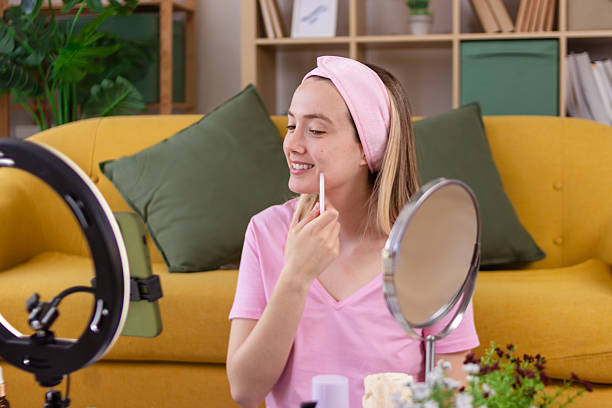 istock Influencer applying makeup while recording video at home 2213233368