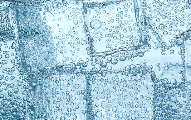 istock Refreshing soda water with ice cubes against white background, closeup 2213233777