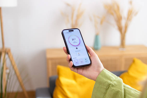 istock Woman using smart home application on mobile phone to control temperature 2213233861