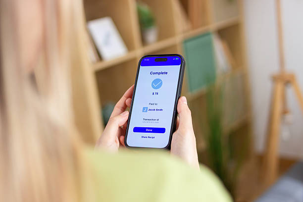 istock Woman holding smartphone showing successful payment confirmation 2213234565
