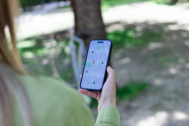 istock Woman navigating with her phone while cycling in a park 2213235079