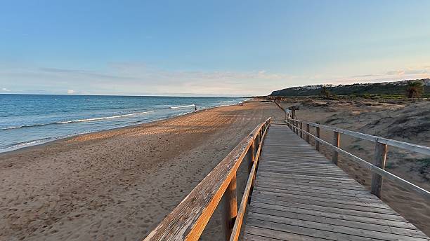 istock A Serene Beach Pathway at Sunset, Where Gentle Waves Gently Caress the Shoreline 2213235755