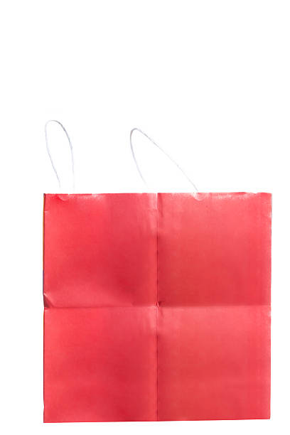 Bright red shopping bag made of paper with white rope handles displayed against a white background. perfect choice for festive occasions, gifting, or retail packaging presentation.