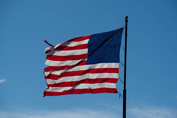 istock American flag waving full against blue sky 2213237276