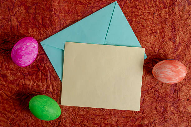 istock Colorful Easter eggs with letter and envelope, on a textured background. 2213246287