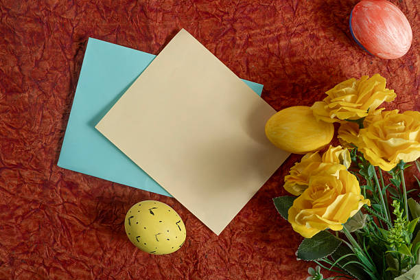 istock Easter decorations with yellow roses, painted eggs and colored paper. 2213246301