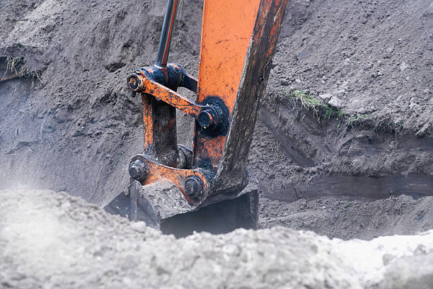 istock Excavator bulldozer bucket digging a hole, trench.Loading bulk 2213248037