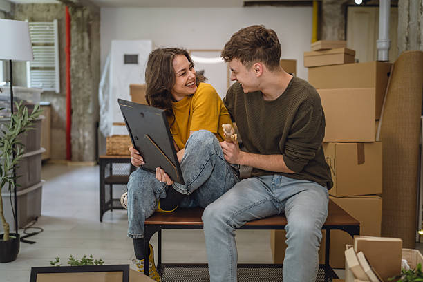 istock Happy adult couple having fun while unpacking boxes together 2213251247