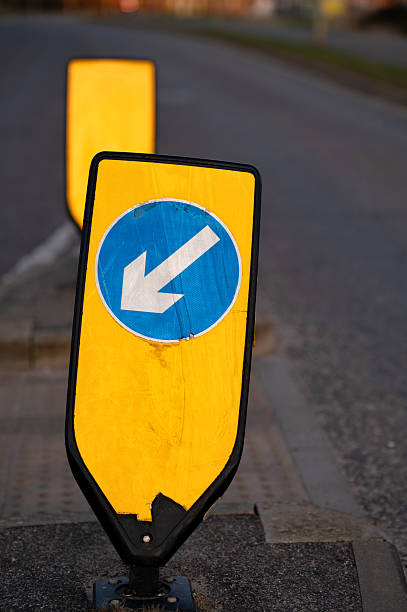 istock Keep left sign. A keep left road sign on a yellow reflective stand. 2213251294