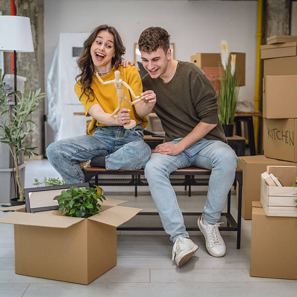 istock Happy adult couple having fun while unpacking boxes together 2213251299
