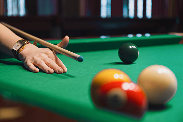 istock Pool Player Lining Up Shot with Cue Stick 2213251730