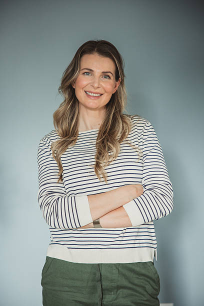 istock Happy mature woman smiling on grey wall 2213252163