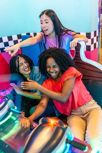 istock Excited multiethnic friends playing arcade games together 2213256245