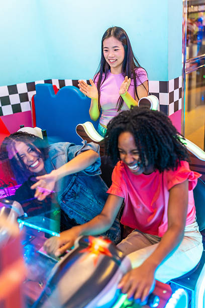 istock Young women having fun playing arcade games together 2213256246