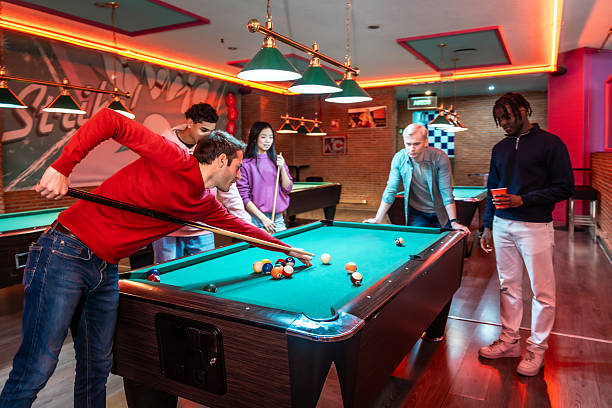 istock Friends playing billiards in a recreation room 2213256257