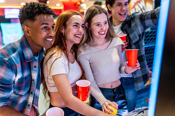 istock Young multiethnic friends playing arcade games and having fun 2213256286