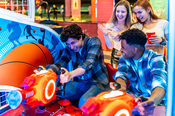 istock Young multiethnic friends playing arcade games on weekend night 2213256295