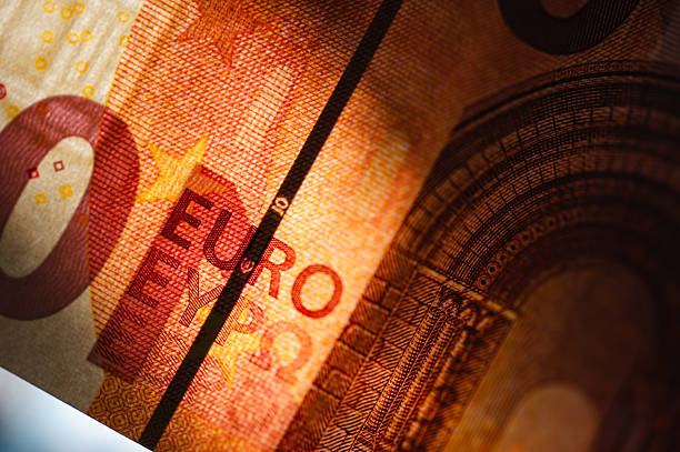 Extreme close-up of a 10 euro banknote showing the detailed texture, color gradients, and the word \