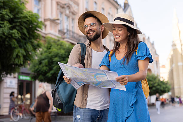 istock Laughing couple with map exploring city during sunny travels. 2213262233