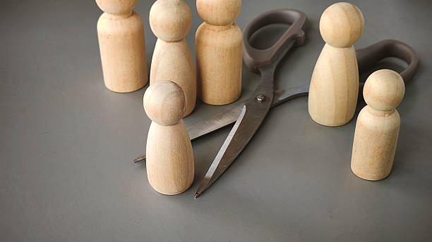 istock Scissors and Wooden People Representing Separation, Decision-Making, and Human Resource Concepts 2213271018