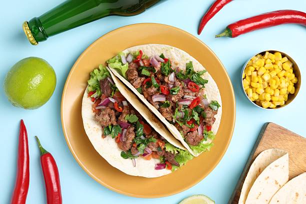 istock Flat lay composition with delicious tacos on light blue table 2213273126
