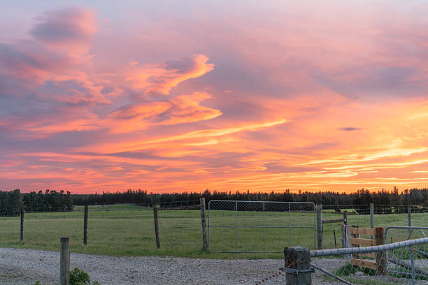 istock Dramatic bright sunset sky over silhouette rural landscape 2213277305