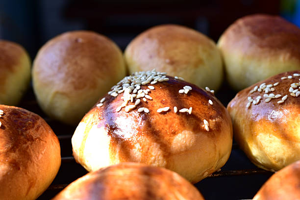 Sweet buns with poppy seeds and filling lie on a white background.