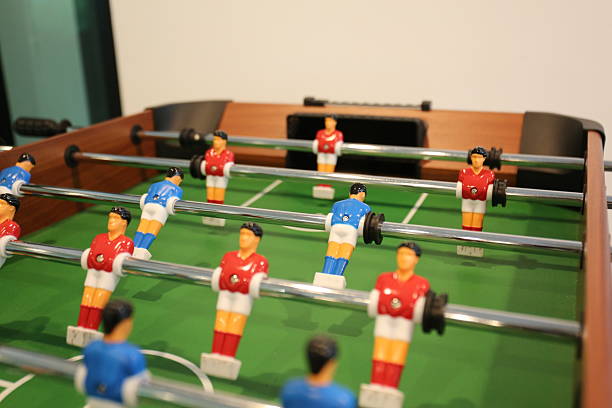 istock foosball table, also known as table soccer, with red and blue players positioned on rods 2213288596