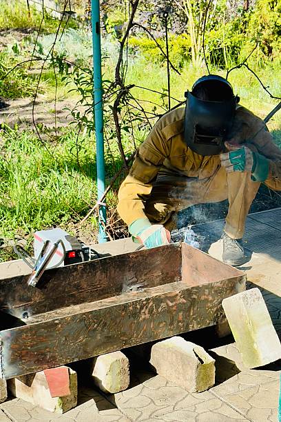 istock welder working on metal structure outdoors 2213288628