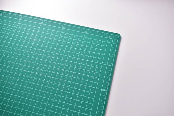 istock green cutting mat board on white background with line and scale measure guide pattern for object art design, tool equipment of diy craft work 2213289798