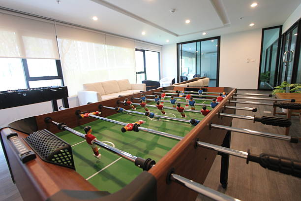 foosball table, also known as table soccer, with red and blue players positioned on rods