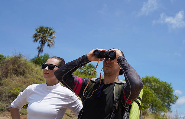 istock A man and a woman are intently looking through binoculars at something interesting in the distance 2213291785